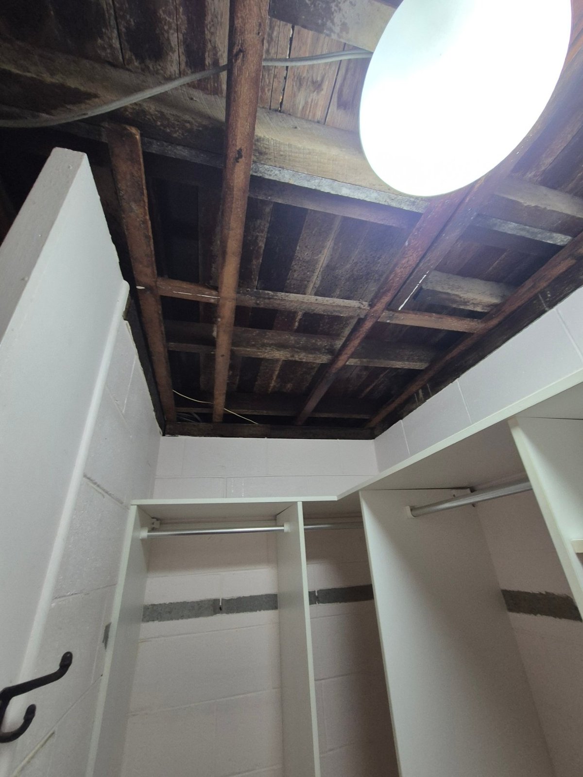 Interior of a Deagon home after asbestos sheet removal, showing exposed timber ceiling framing and a skylight